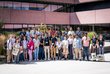 Group photo of OeAD scholars and OeAD staff in front of a building on ISTA campus