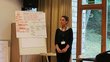 Margarit Tigranyan, a university lecturer from Armenia,  in front of a flipchart during the Organic Leadership Course in Lithuania