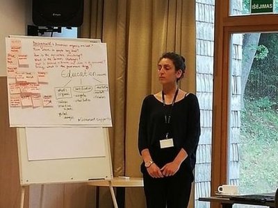 Margarit Tigranyan, a university lecturer from Armenia,  in front of a flipchart during the Organic Leadership Course in Lithuania