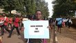 Demonstration march in the town of Kingali in Rwanda. A woman holds up a sign with the words: Social workers for Equity..