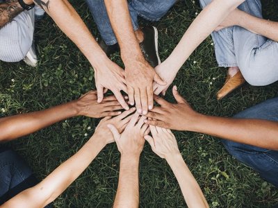 Hände, die in der Mitte aufeinander treffen