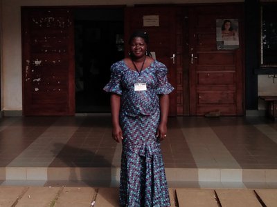 Young female student standing in front of university building