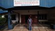 Young female student standing in front of university building