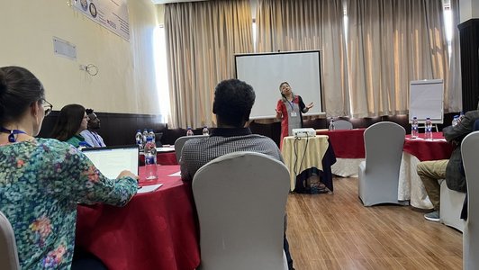 A woman speaking in front of an audience