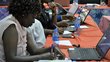 Women sitting and writting on a workingtable