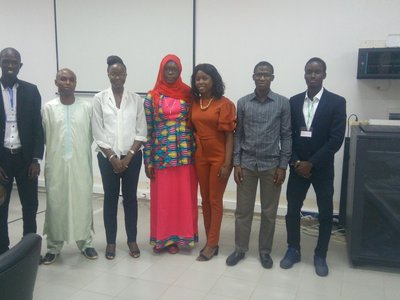 Group of people standing in a row and posing for a picture