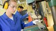 Young woman at a machine in production