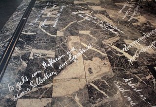  Sayings were written in white on the black and white marble floor.