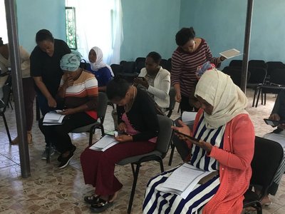 Group of women where each is looking at her tablet 