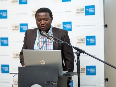 Photo of Vianney Kambale speaking at the IEEE ICTAS Conference