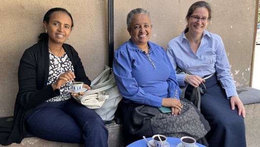 Three women sitting on a bench