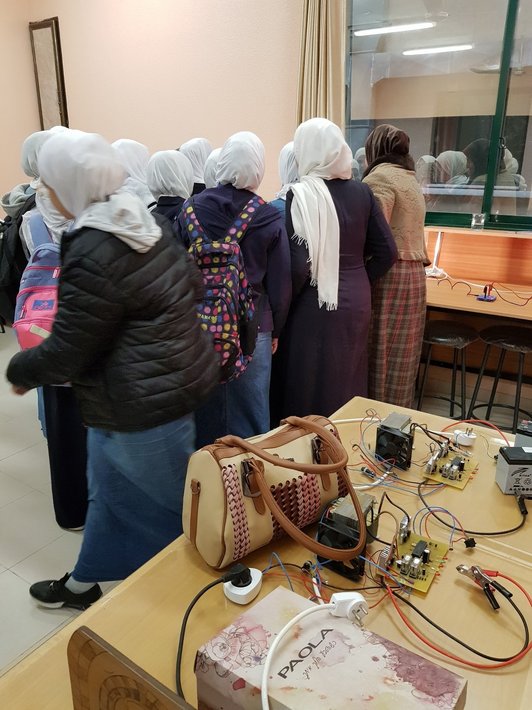 Female high school students inspect renewable energy lab