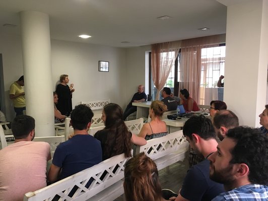 Group of people sitting in rows in a room 