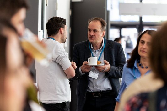 Participants talk during the coffee break