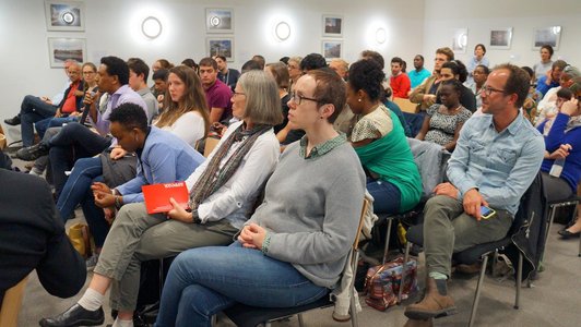 Group of people sitting arranged in rows