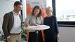 Group photo with Patrick Siegele, Deborah Hartmann and Regine Mathies standing around a bar table.