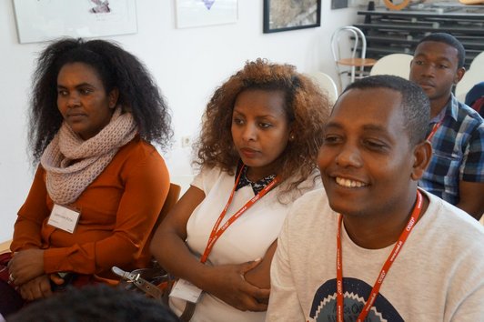 Three OeAD scholarship holders sit in the audience.