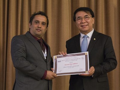 Dr. Basanta Adhikari and a second man holding a certificate