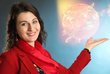 Female scientist holding her dissertation and pointing at a grafic in the background