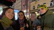 Four young students take a picture of themselves outside late in the evening. Everyone is dressed vor colder weather.