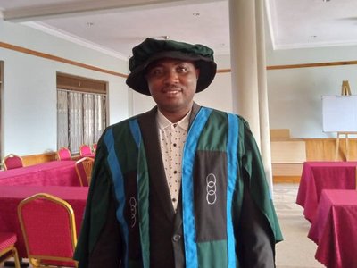 Thaddeo in Phd graduation gown