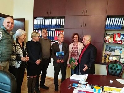 Group of people posing for a group picture standing in a room