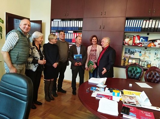 Group of people posing for a group picture standing in a room