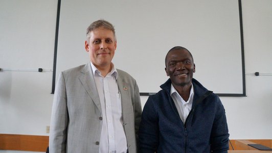 Two of the IIASA members who were talking to the students are smiling into the camera