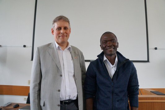 Two of the IIASA members who were talking to the students are smiling into the camera