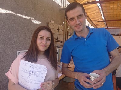 Scholarship holder Hasmik Hovakimyan holding her workshop notes and standing next to a workshop participant