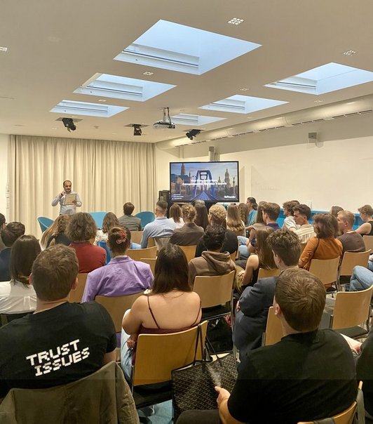 Speaker presenting and audience listening