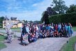 The scholarship holders in a group photo in front of a castle with a park and unicorn statues in Salzburg.