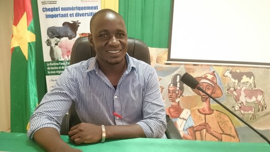 Young scholarship holder from Burkina Faso sitting on a chair in front of the microphone preparing for an interview