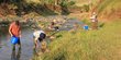 Two scientists looking for water quality and fish in a river in Ethiopia