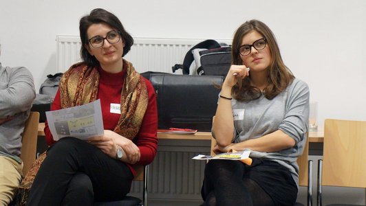 Two women sitting in chairs