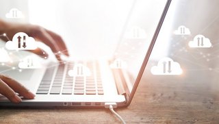 Cloud computing concept, Businessman using laptop with white clouds computing network connection and data exchange , block chain, online storage and internet communication.