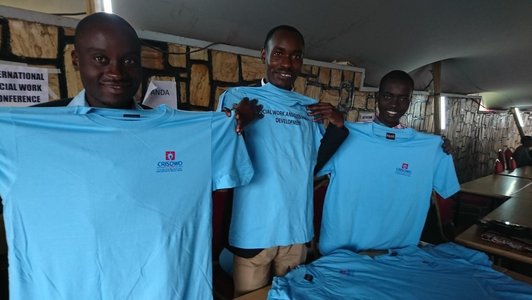 Three men presenting the blue CRISOWO conference T-shirts