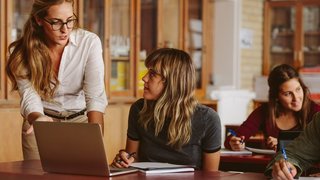 Lehrerin spricht mit Schülerin