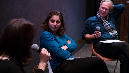 the moderator of the film days event is asking questions to the two panellists