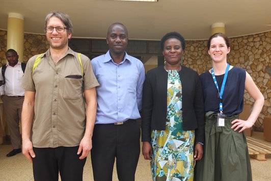Group of people posing for a picture in front of a building