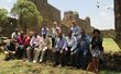 Group of people posing for a picture in front of a castle