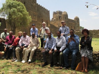 Group of people posing for a picture in front of a castle