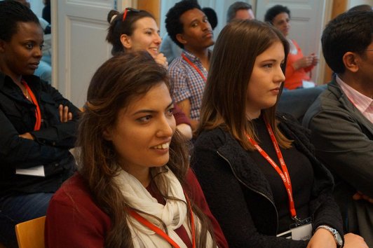 OeAD scholarship holders sit in the audience at an event in Graz.