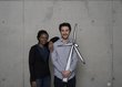 A woman and a man are holding a pinwheel recorded on cardboard.