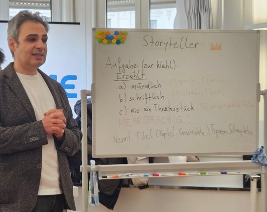 Mann steht vor Whiteboard und redet