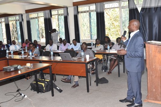 photo of male speaker and audience