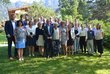 The participants of the OeAD event at the European Forum Alpbach stand in a green meadow and look towards the photographer.