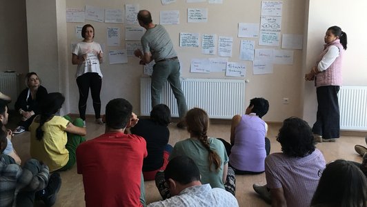 Participants presenting their findings in a group setting