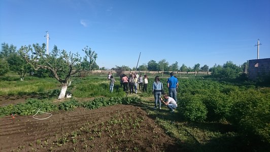 Group of people standing on an agricultural field