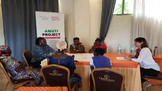 People sitting around a table and discussing.